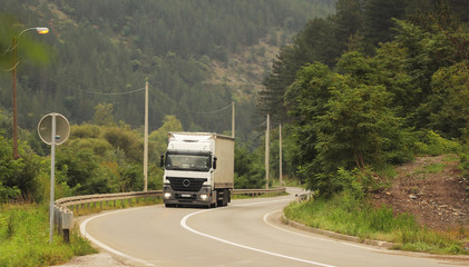 Fototapeta na wymiar Truck on the road in a sharp curve