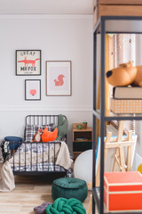 Cute vintage style posters on white wall of trendy bedroom for child