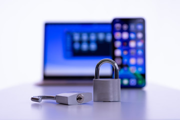 Privacy and data protection: Laptop and smartphone with locked and unlocked padlock