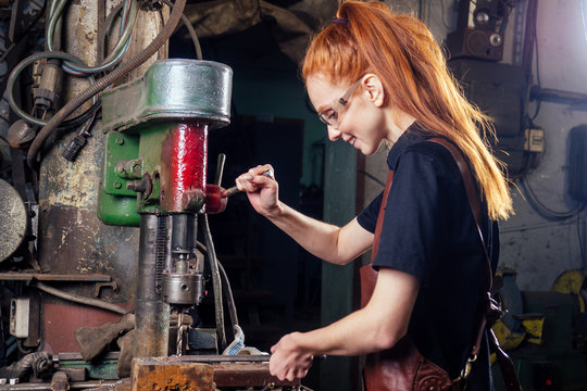 redhead ginger woman blacksmith portrait in workshop
