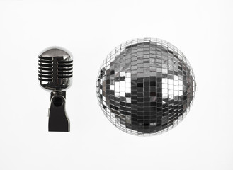 vintage silver microphone and disco ball on a white background