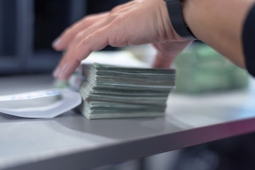 Bank employees sorting and counting money inside bank vault. Large amounts of money in the bank.