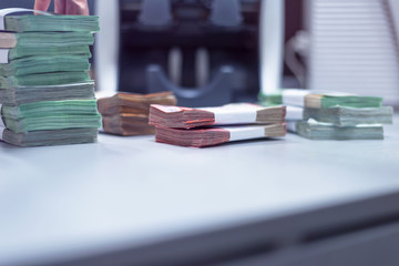Bank employees sorting and counting money inside bank vault. Large amounts of money in the bank.