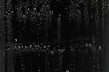 Obraz premium black wet background / raindrops for overlaying on window, concept of autumn weather, background of drops of water rain on glass transparent