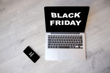 Black friday concept on a computer. Computer with black friday concept on the screen and smartphone with call action screen