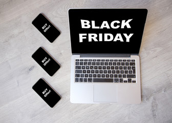 Black friday concept on a computer. Computer with black friday concept on the screen and smartphones with call action screen