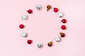 Background with a Little Christmas Red and Silver Balls are Lying on Pink Background in Shape of Christmas Wreath Christmas Festive Mood Flat Lay or Modern Minimal Holiday Concept