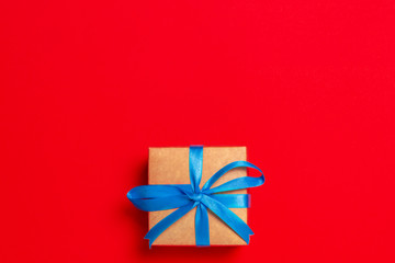 Gift box on a red background. Holiday concept, christmas. Flat lay, top view