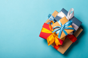 Stack of gifts on a blue background. Gift concept for a loved one, holiday, Christmas. Flat lay, top view