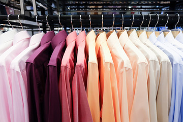 Colorful shirts hanging on rack