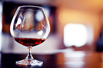 red wine glass serving / romantic dinner in the interior of the restaurant, a table served with a glass of grapes wine