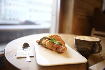 breakfast in a French cafe / croissant with salmon and salad for breakfast in a restaurant