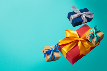 Flying gift boxes on a blue background. Holiday concept, christmas. Levitation. Items in the air. Flat lay, top view