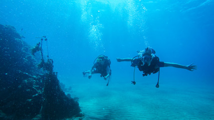 Diving with air balloon in the red sea. Instructor. Girl and coral reefs. Traveling lifestyle. Water sports. Beach holidays.
