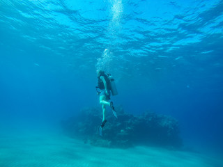 Diving with air balloon in the red sea. Instructor. Girl and coral reefs. Traveling lifestyle. Water sports. Beach holidays.