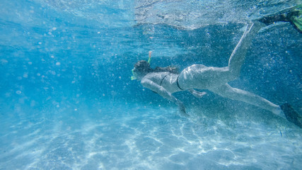 Diving in the red sea. Sexy girl in bikini and mask. Snorkeling. Traveling lifestyle. Water sports. Beach holidays.