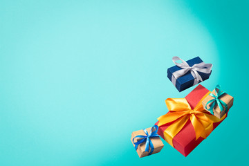 Flying gift boxes on a blue background. Holiday concept, christmas. Levitation. Items in the air. Flat lay, top view