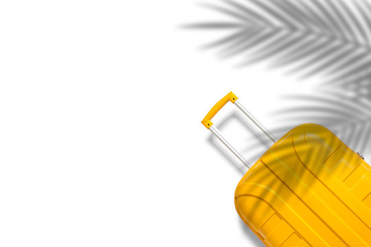 Yellow suitcase under the shadow of palm leaves on a white background. Travel and vacation concept in triples. Flat lay, top view