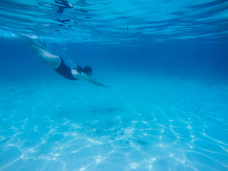Naklejka premium Diving in the red sea. Sexy girl in bikini and mask. Snorkeling. Traveling lifestyle. Water sports. Beach holidays.