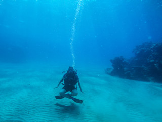 Diving with air balloon in the red sea. Instructor. Girl and coral reefs. Traveling lifestyle. Water sports.Yoga underwater