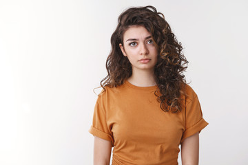 Upset tired young armenian curly-haired woman feel exhausted let down look disappointed insulted...
