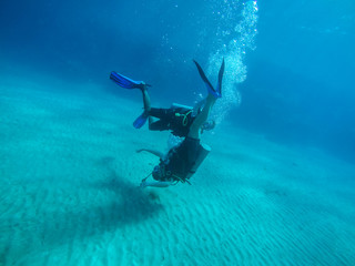 Diving with air balloon in the red sea. Instructor. Girl and coral reefs. Traveling lifestyle. Water sports.Yoga underwater