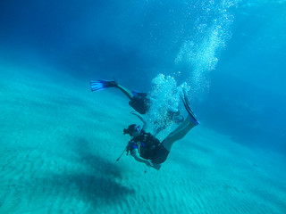 Diving with air balloon in the red sea. Instructor. Girl and coral reefs. Traveling lifestyle. Water sports.Yoga underwater