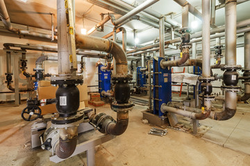 pumping station under construction. pipes of central heating system and water pipes with thermal...