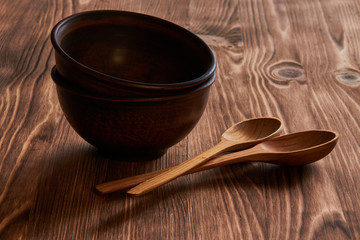 homemade clay plates with wooden spoons on a wooden table
