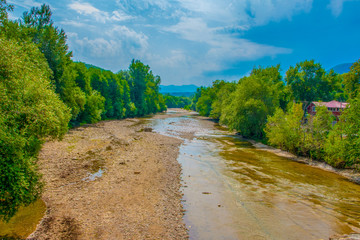 River running along the cliff, and forest. Belaya river, Republic of Adygea, Russia