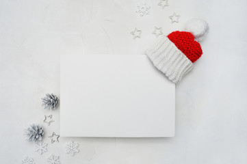 Letter mockup to Santa Claus with Santa red hat on wooden background. Christmas background with cones and snowflakes