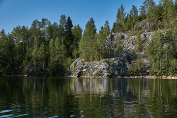 Water landscape of a mountain park.The picturesque landscape of the mountain natural park Ruskeala. Visible are rocks, a lake, coniferous forest, mountains, wildlife. Russia, Karelia