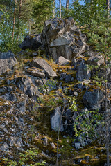 Land landscape mountain park.The picturesque landscape of the mountain natural park Ruskeala. You can see the rocks and their fragments, coniferous forest, mountains, wildlife. Russia, Karelia