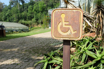 Wooden handicapped sign. Walking path for disable people with sign.