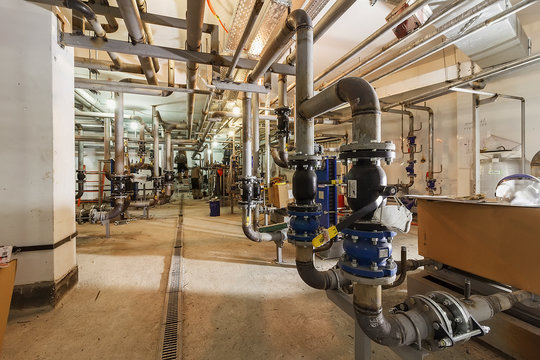 Industrial Factory equipment stainless tubes Food automation. Equipment, cables and piping as found inside of modern industrial power plant. Pipeline assembly. District heating substation.