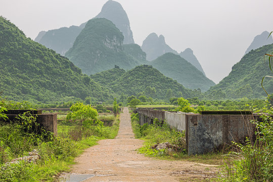 Small road through farmland in the karst hills in the vicinity of Yangshuo near Guilin