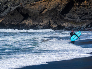 California Surfer and his turquoise Board enjoy the sea