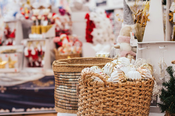  shiny christmas balls in wicker basket in a store.