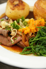 Gourmet roast beef lunch with roast potato, yorkshire pudding swede and samphire