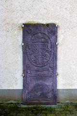 Old tombstone, Church of St. Wendelin of Trier bell tower in Wallerode, Belgium