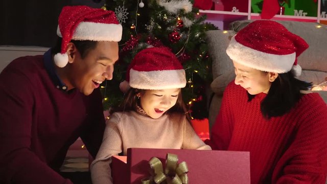 4K Slow motion: Asian family Parents and daughters are celebrating Christmas. Give gifts to each other. Arranging a New Year's celebration in the house
