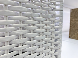 Traditional white rattan wicker basket close up in a store