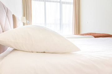 A bed with white sheets and pillows close up at a hotel appartment