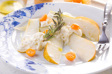 traditional pear and cheese salad on a white plate