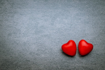 Obraz premium Two lovers hearts on gray background with copy space. Valentines day concept.