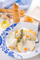 traditional pear and cheese salad on a white plate