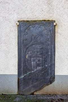 Old tombstone, Church of St. Wendelin of Trier bell tower in Wallerode, Belgium