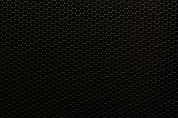 Black metal sheet background with holes