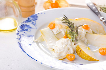 traditional pear and cheese salad on a white plate