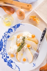 traditional pear and cheese salad on a white plate